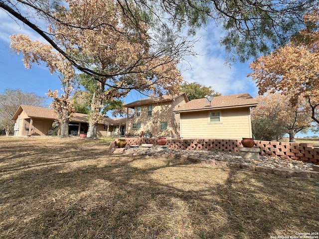 back of property featuring a yard