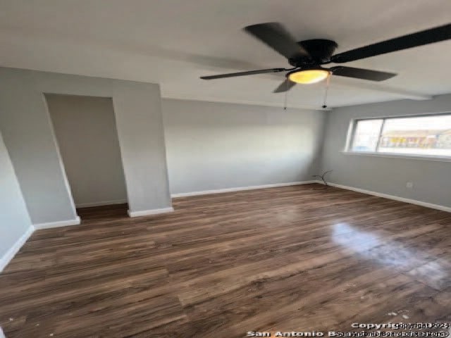 empty room featuring dark wood-type flooring and ceiling fan