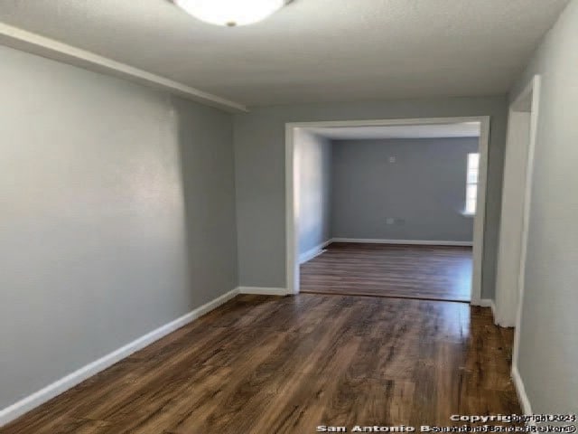 unfurnished room featuring dark hardwood / wood-style floors