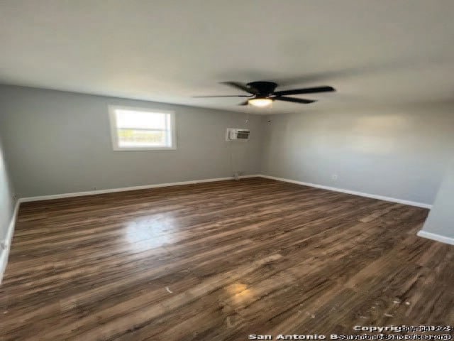 empty room with dark wood-type flooring and ceiling fan