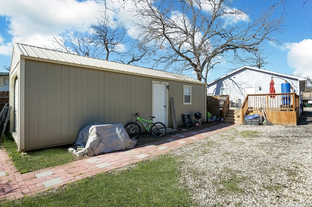 rear view of property featuring a wooden deck