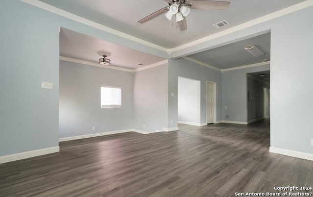 empty room with crown molding, dark hardwood / wood-style flooring, and ceiling fan