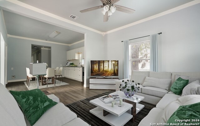 living room featuring ceiling fan, dark hardwood / wood-style floors, and ornamental molding