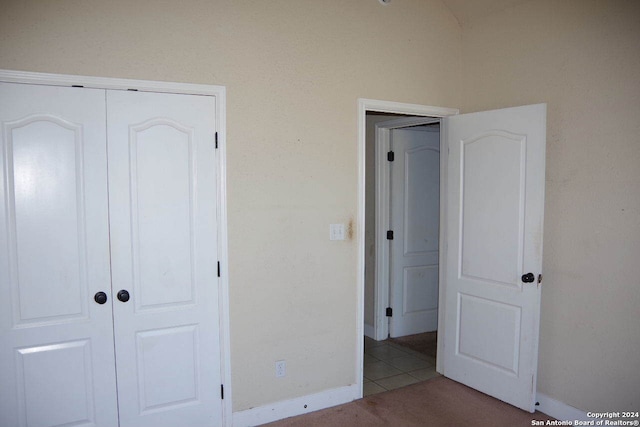 unfurnished bedroom with a closet and light tile patterned flooring