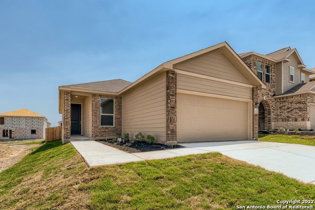 view of front of property featuring a garage and a front lawn