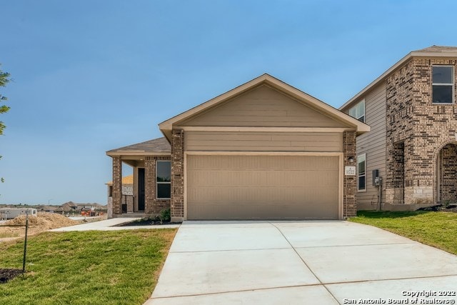 view of front of home featuring a garage and a front lawn