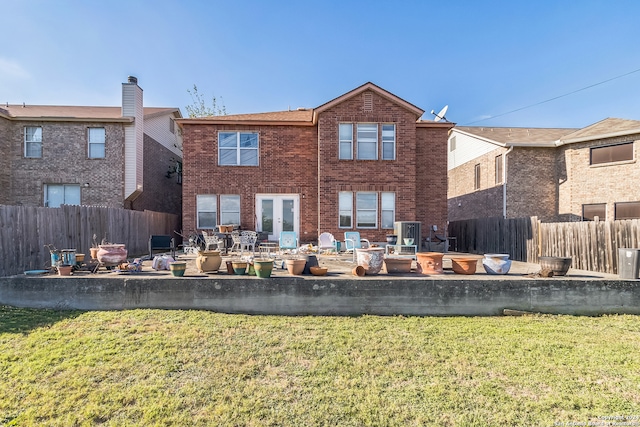 rear view of house with a lawn and a patio area