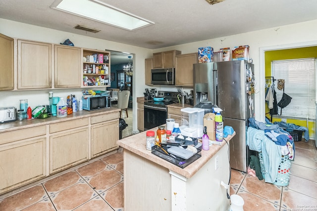 kitchen featuring a textured ceiling, stainless steel appliances, light brown cabinets, light tile patterned floors, and a center island