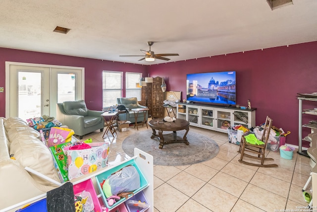 living room featuring tile patterned floors, ceiling fan, and french doors