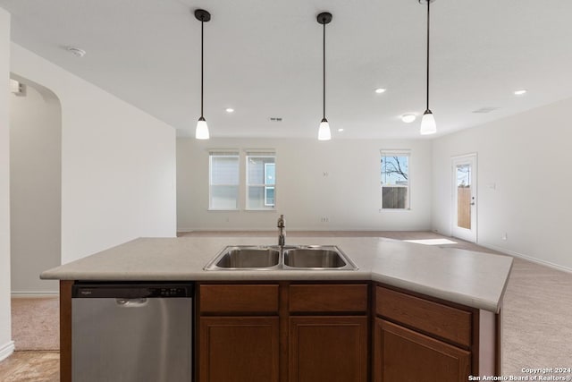 kitchen featuring stainless steel dishwasher, decorative light fixtures, sink, and light carpet