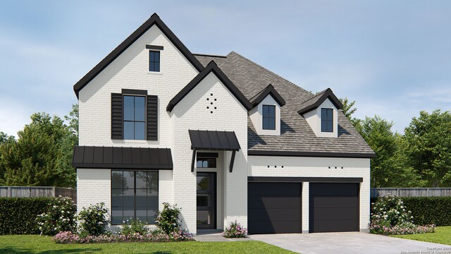 view of front of house with a front yard and a garage