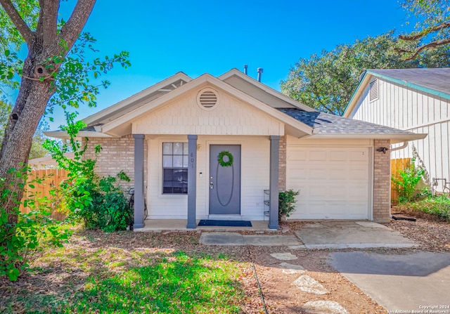 view of front of property with a porch and a garage