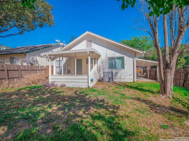 back of house featuring a sunroom and central AC