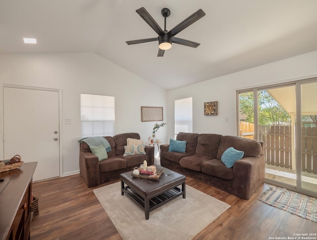 living room with ceiling fan, dark hardwood / wood-style flooring, and vaulted ceiling