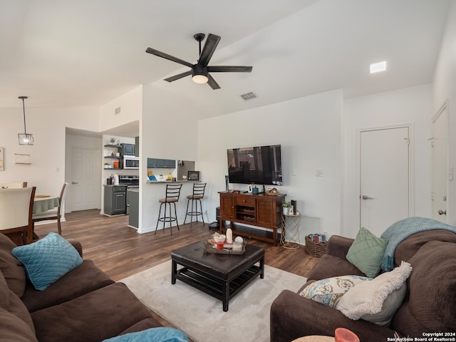 living room with hardwood / wood-style flooring, vaulted ceiling, and ceiling fan