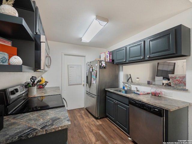 kitchen featuring dark hardwood / wood-style flooring, stainless steel appliances, and sink