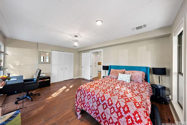 bedroom with a closet and dark hardwood / wood-style flooring