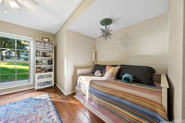 bedroom with wood-type flooring, ceiling fan, and ornamental molding