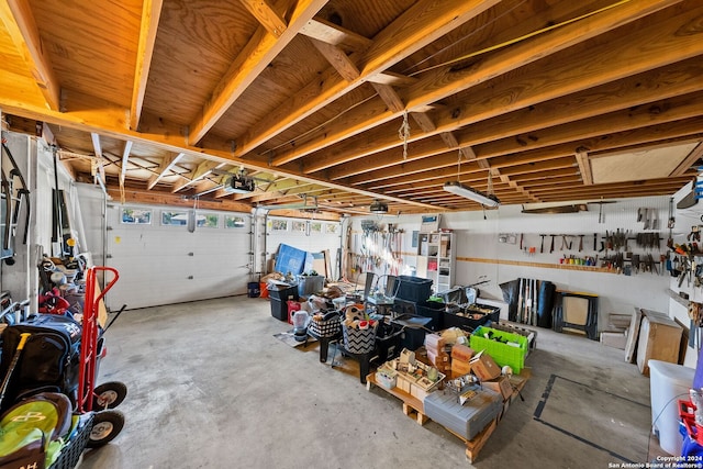 garage with a workshop area and a garage door opener