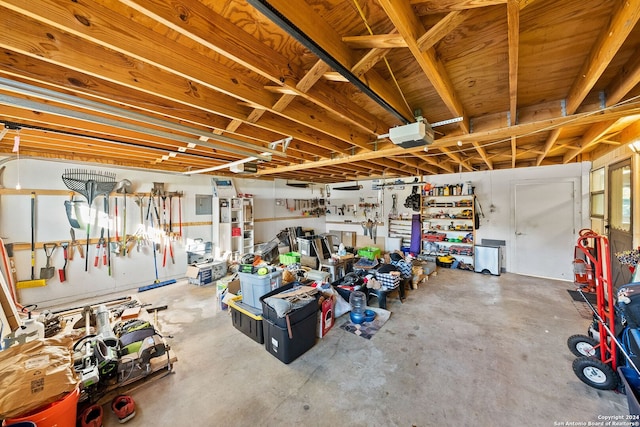 garage with a workshop area and a garage door opener