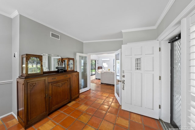 entrance foyer with tile patterned floors and crown molding