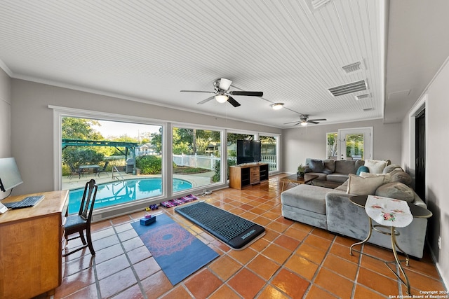 tiled living room with plenty of natural light, crown molding, and ceiling fan