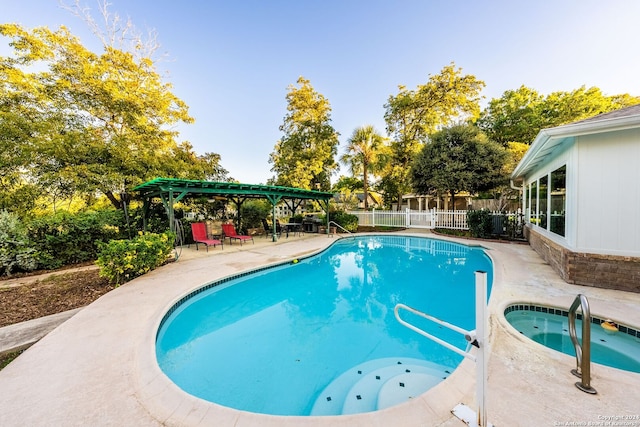 view of swimming pool featuring a patio area, a pergola, and an in ground hot tub