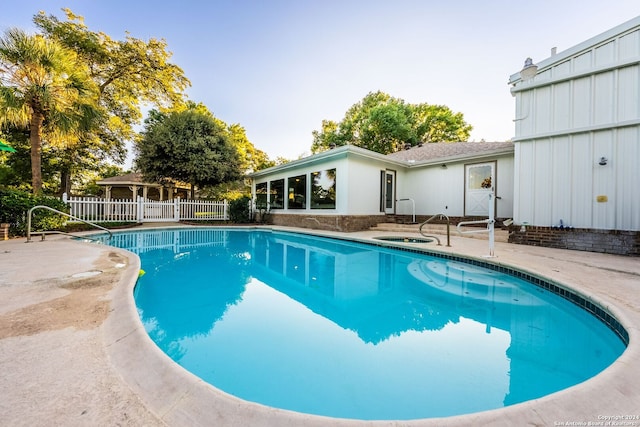 view of pool featuring an in ground hot tub and a patio