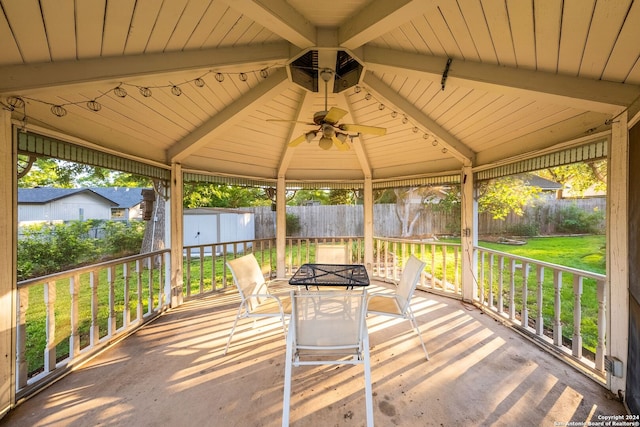 wooden deck with a gazebo, a shed, and a lawn