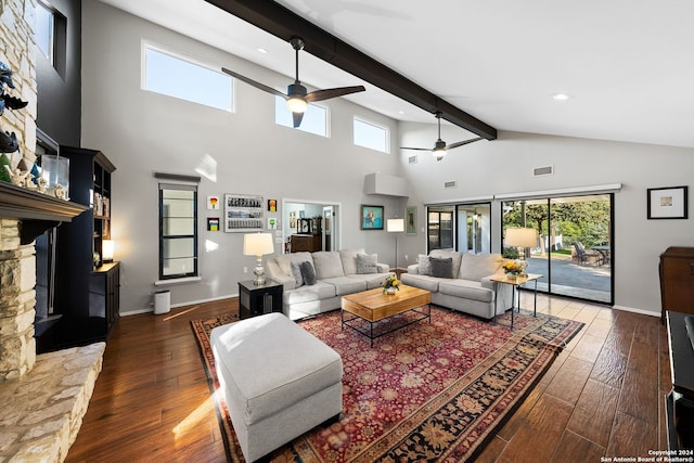 living room with beam ceiling, ceiling fan, dark wood-type flooring, and a healthy amount of sunlight