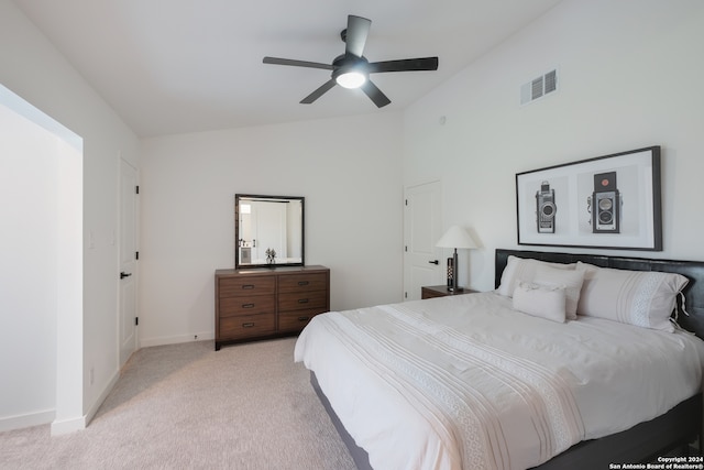 carpeted bedroom with ceiling fan and lofted ceiling