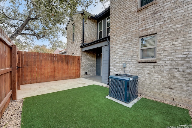 view of yard featuring central AC and a patio