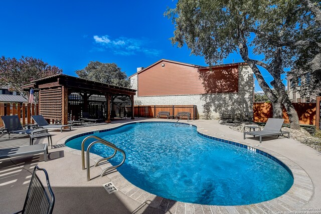 view of pool featuring a pergola and a patio