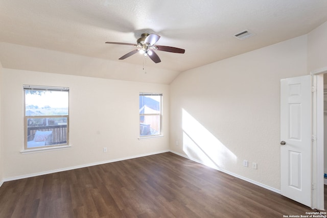 unfurnished room featuring a textured ceiling, dark hardwood / wood-style flooring, ceiling fan, and lofted ceiling