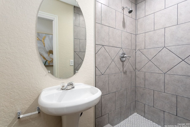 bathroom with sink and tiled shower