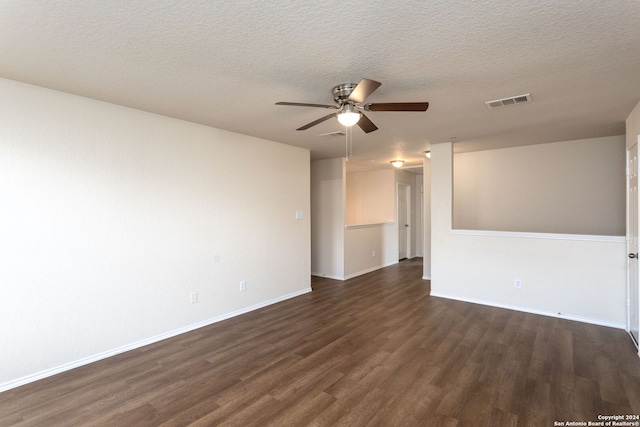 unfurnished room with a textured ceiling, ceiling fan, and dark wood-type flooring