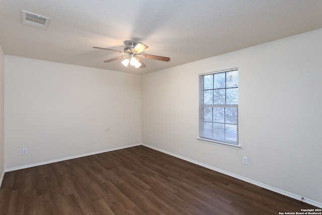 spare room with ceiling fan, dark hardwood / wood-style flooring, and a textured ceiling