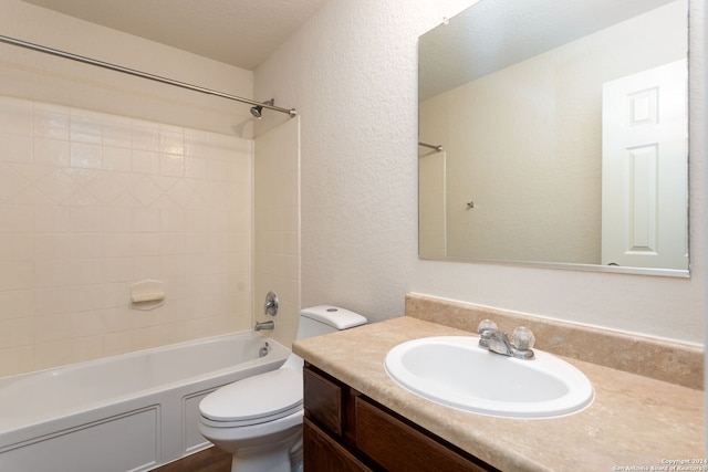 full bathroom with vanity, toilet, washtub / shower combination, and a textured ceiling