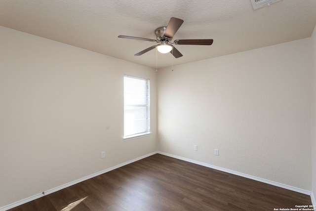 unfurnished room with ceiling fan and dark wood-type flooring