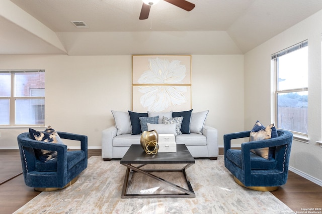 living room with ceiling fan, hardwood / wood-style floors, and lofted ceiling