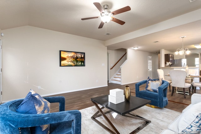 living room featuring vaulted ceiling, hardwood / wood-style floors, a textured ceiling, and ceiling fan with notable chandelier