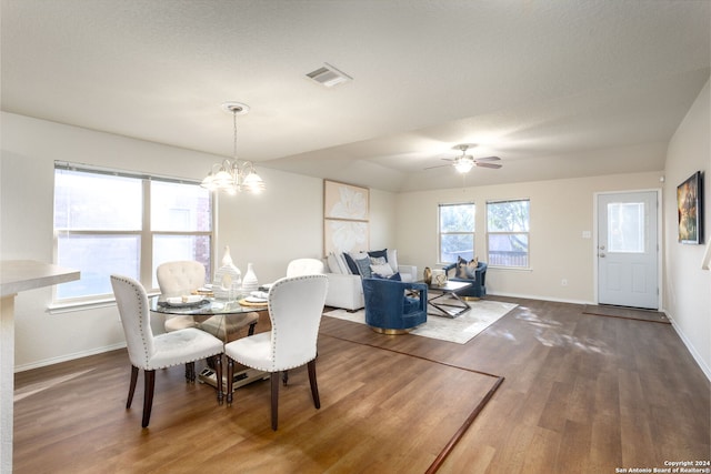 dining room featuring ceiling fan with notable chandelier, dark hardwood / wood-style flooring, and a textured ceiling