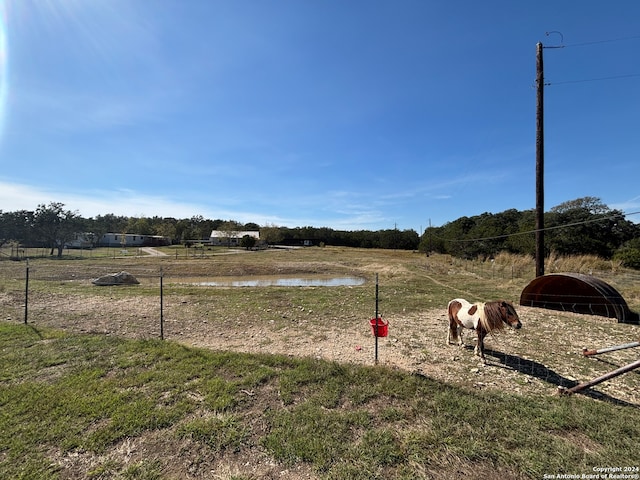 view of yard featuring a rural view and a water view