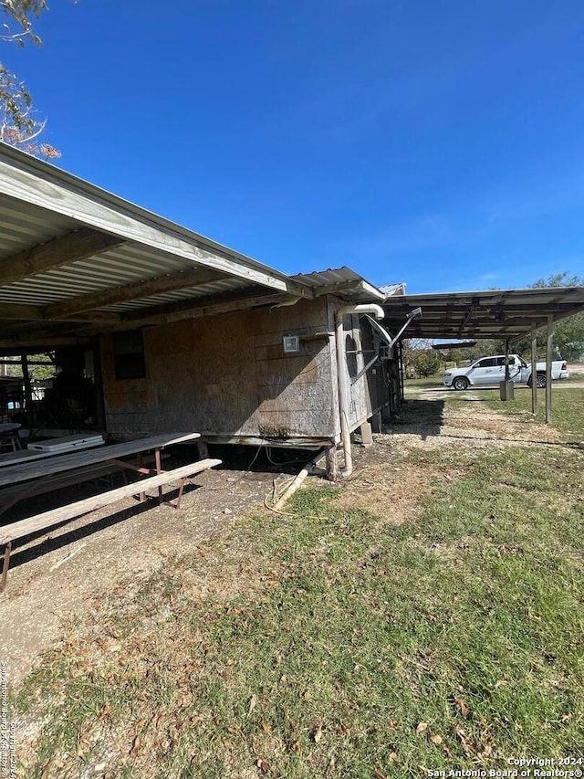 view of side of property featuring a carport