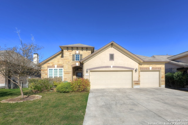 view of front of home with a garage and a front lawn