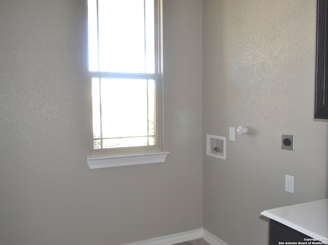 clothes washing area with electric dryer hookup and washer hookup