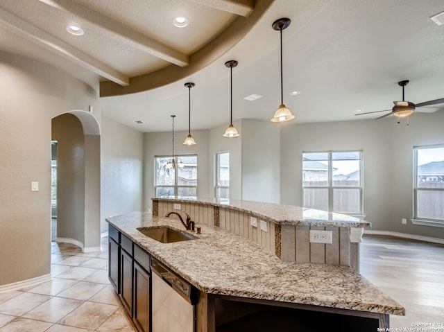 kitchen with dishwasher, a kitchen island with sink, sink, hanging light fixtures, and ceiling fan