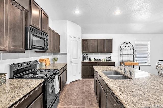 1422 Scent Of Basil, San Antonio, TX 78245 - kitchen with black appliances, a sink, a textured ceiling, dark brown cabinets, and light stone countertops