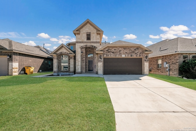 view of front of house with a front yard and a garage