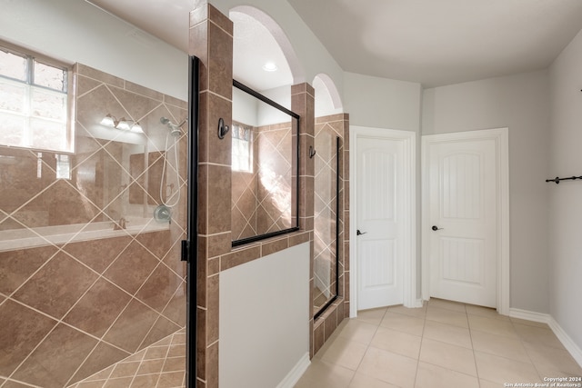 bathroom featuring tile patterned floors and a shower with door